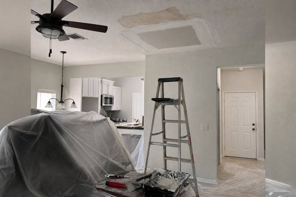 Ceiling drywall repair setup below a water stain for Brevard County drywall projects