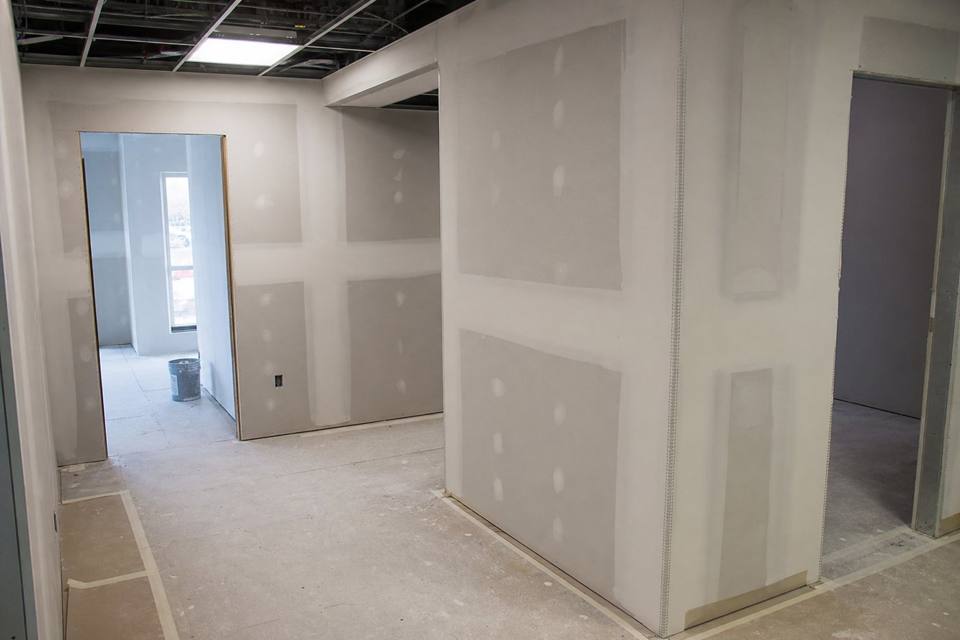 Commercial drywall finishing with corner bead and floor protection for Brevard County drywall projects