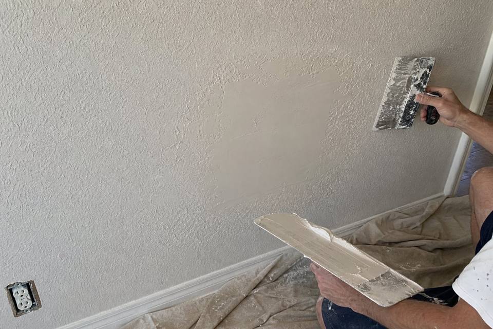 Texture matching and drywall patch repair in progress for Brevard County drywall projects